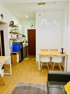 a living room with a table and a kitchen at Bayanihan Flats 2 in Mactan