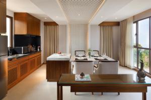 a kitchen with a table and some chairs in a room at Dusit Thani Himalayan Resort Dhulikhel, Nepal in Dhulikhel