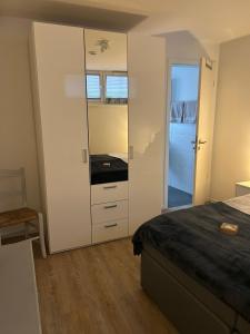 a bedroom with a bed and a dresser and a mirror at Warendorf 14 in Warendorf