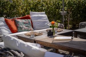 a couch and a table with pillows on it at 3 Sterne Boutique Gasthaus Pöstli in Rifferswil