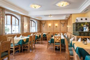 a restaurant with tables and chairs in a room at Hotel Garni Carl Michael in Strobl
