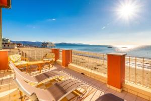 a balcony with chairs and a view of the beach at Villino Gelli in Follonica