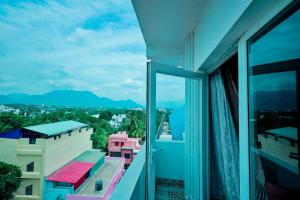 a balcony with a view of a city at Hotel Rieejh in Nāgercoil