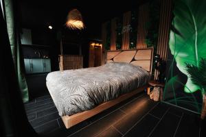 a bedroom with a bed in a room at Jungle Room Dunkerque centre in Dunkerque