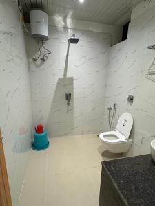 a bathroom with a toilet and a sink at The Lazymojo in Tāla +7 photos