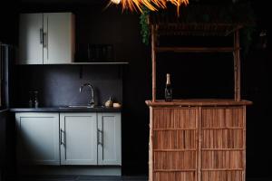 a kitchen with white cabinets and a sink and a ladder at Jungle Room Dunkerque centre in Dunkerque