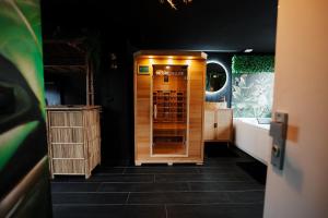 a bathroom with a wooden cabinet and a sink at Jungle Room Dunkerque centre in Dunkerque +25 photos