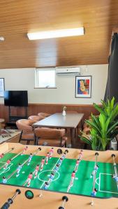 a room with a table with a group of people spelled at 9Stay函館 in Hakodate