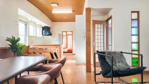 a dining room with a table and chairs at 9Stay函館 in Hakodate +104 photos