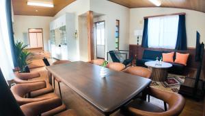 a living room with a table and chairs at 9Stay函館 in Hakodate