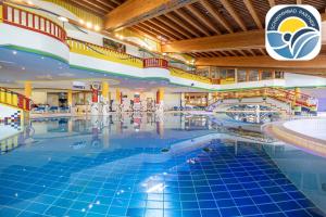 a large swimming pool in a shopping mall at Appart & Hotel Garni Villa Knauer in Mayrhofen