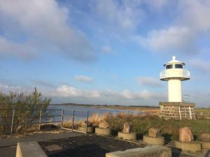 a lighthouse sitting next to a body of water at Am Hafen 13 in Glückstadt