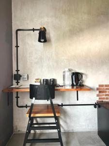 a lamp on a shelf in a kitchen at d'primahotel Yogyakarta in Yogyakarta +11 photos