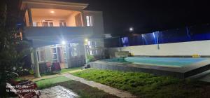 a house with a swimming pool at night at Blue Horizon Villa in Grand Baie in Grand-Baie