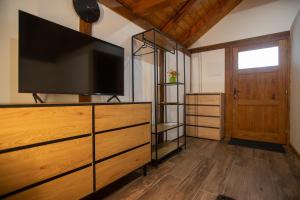 a living room with a flat screen tv on a dresser at Savoy Village in Čokadinci