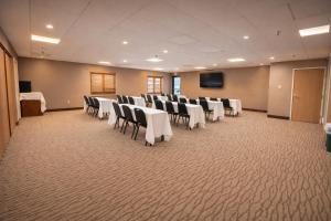 a conference room with chairs and tables and a screen at Comfort Inn Owatonna near Medical Center in Owatonna +18 photos