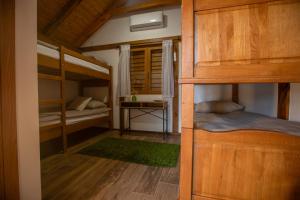 a bedroom with two bunk beds and a green rug at Savoy Village in Čokadinci +35 photos