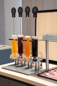 a tray with four glasses of beer on a counter at WE Hotel EXPO Prague in Prague