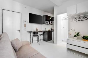 a living room with a couch and a kitchen at Borgo Riccio - Nice place in Parma in Parma