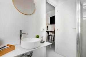 a bathroom with a large white sink and a mirror at Borgo Riccio - Nice place in Parma in Parma