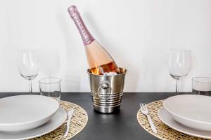 a bottle of champagne in a bucket on a table with glasses at Borgo Riccio - Nice place in Parma in Parma +13 photos