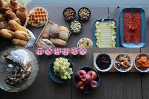 a table with a bunch of different types of food at VISIONAPARTMENTS Basel - self check-in in Basel