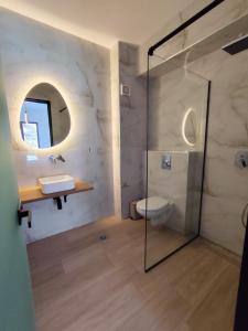 a bathroom with a shower and a toilet and a sink at White Rocks Meteora in Kalabaka