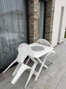 two white chairs and a table on a patio at Magnifique studio in Bressols