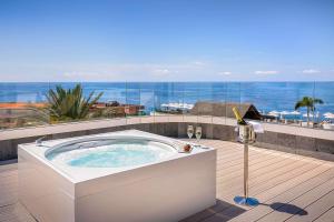 a hot tub on a deck with a view of the ocean at Barceló Santiago - Adults Only in Puerto de Santiago