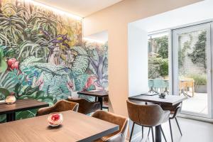 a mural in a restaurant with tables and chairs at VISIONAPARTMENTS Basel - self check-in in Basel