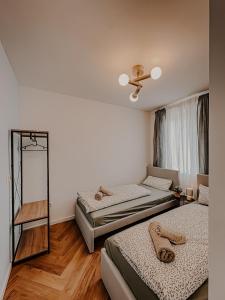 a bedroom with two beds and a mirror at Batu Apartment in Viernheim