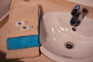 a towel sitting on top of a bathroom sink at Ecoland Casa de Campo in Mértola +77 photos