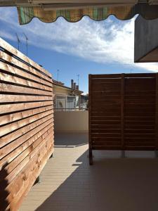 a wooden fence in front of a house at Appartamento Trieste Airport in Ronchi dei Legionari
