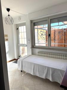 a bedroom with a bed and a large window at Appartamento Trieste Airport in Ronchi dei Legionari
