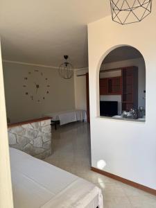 a room with a bed and a clock on the wall at Appartamento Trieste Airport in Ronchi dei Legionari