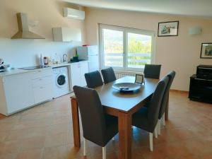 a kitchen with a dining room table and chairs at Villa Toti in Montepaone