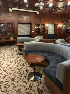 a waiting room with couches and tables in a lobby at Hotel Bishops Arms Malmö in Malmö