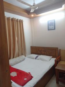 a small bedroom with a bed and a ceiling at Hotel Sikder-02 Residential in Dhaka +3 photos