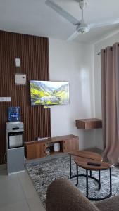 a living room with a tv on the wall at Bahari Home in Nyali
