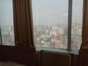 a window in a hotel room with a view of a city at Hotel Sikder-02 Residential in Dhaka