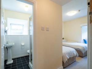 a bathroom with a bed and a sink and a toilet at The Convent Leenane in Leenaun +43 photos