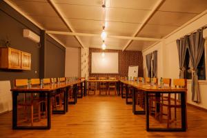 a large room with tables and chairs and a screen at Casa Mara Dakar in Dakar +247 photos