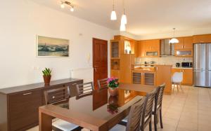 a kitchen with a table and a dining room at Gi & Vi House in Agios Nikolaos