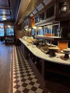 a kitchen with a checkered floor at Hotel Bishops Arms Malmö in Malmö