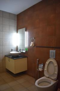 a bathroom with a toilet and a sink and a mirror at Vista Del Lago - Lakeview Homestay in Ambalavayal +105 photos