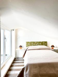 a bedroom with a bed and a large window at Casa Verde Oliva - WelcHome in Rocca San Giovanni