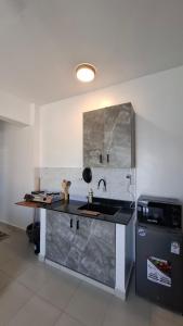 a kitchen with a sink and a refrigerator at Bahari Home in Nyali