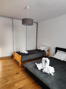 a room with two beds with white towels on them at Berryblossom Estate in Krosno
