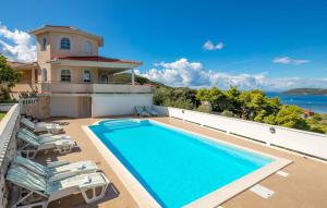 a swimming pool on the side of a house at Villa Superior in Rab