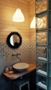 a bathroom with a sink and a mirror at Chatová osada Slunečnice in Vlčice +29 photos